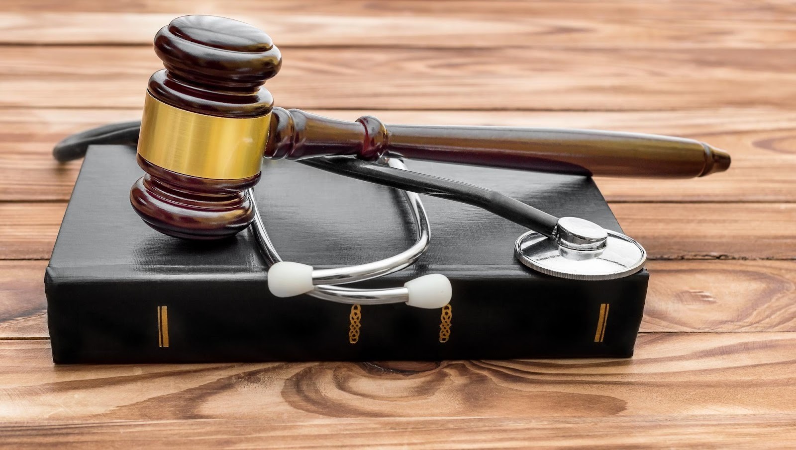 Gavel and stethoscope resting on a law book, symbolizing medical law